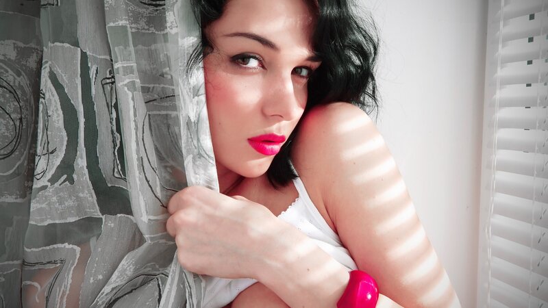 woman with pink lipstick by window