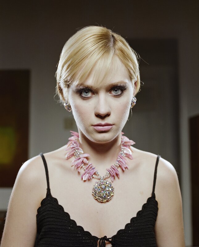 woman with pink necklace