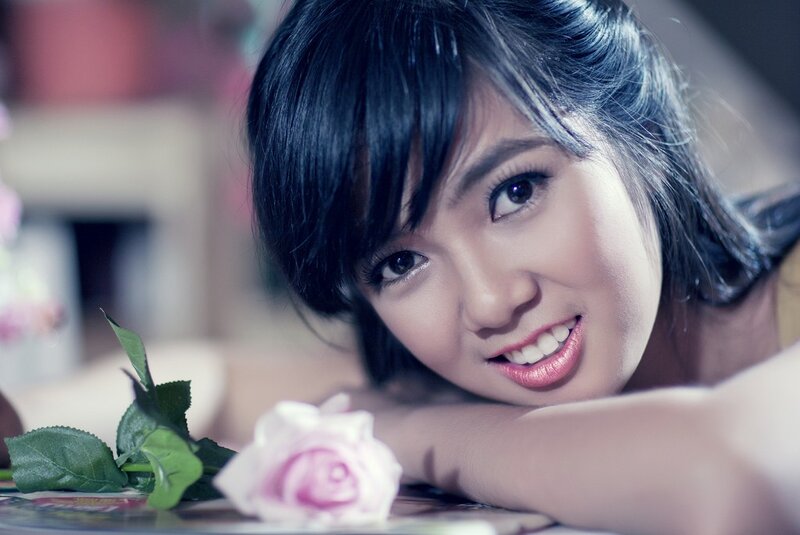 woman with pink rose