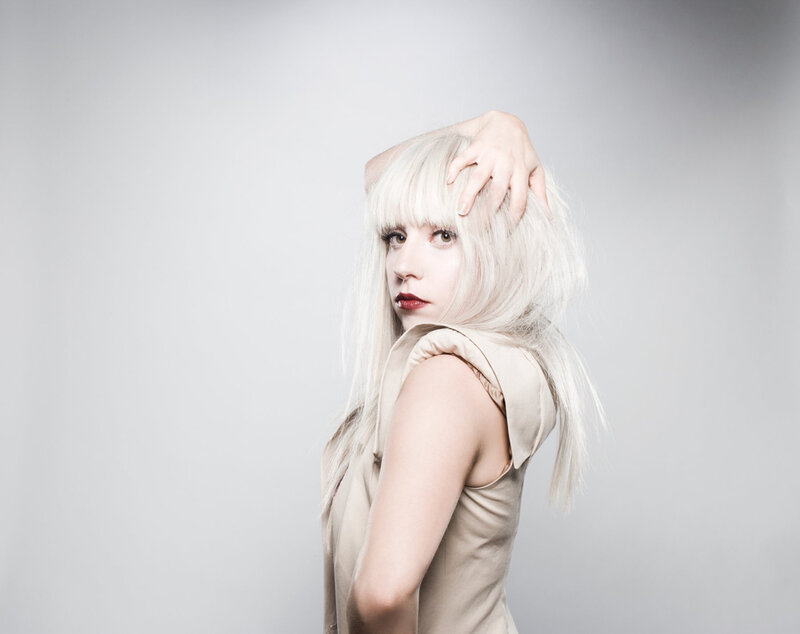 Woman with Platinum Hair — White, Dramatic, Photograph, Blonde Hair, Red Lipstick, Hand, Beige