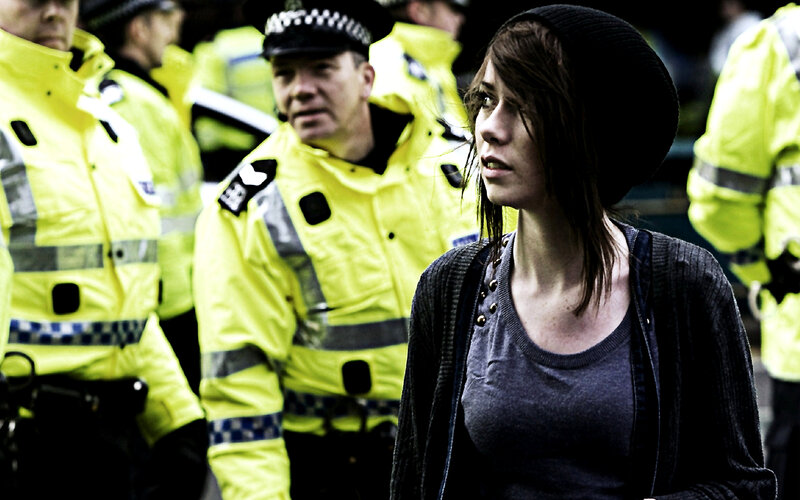 Woman with police officers in background