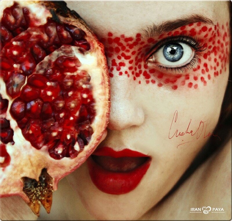 woman with pomegranate and red makeup