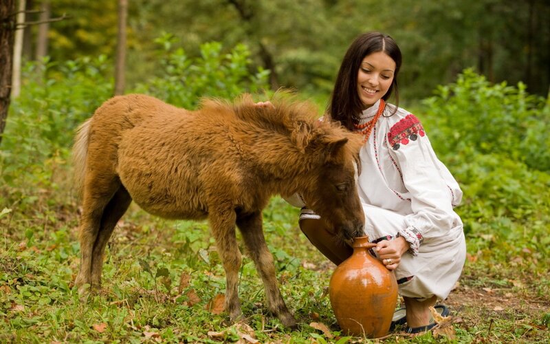 Woman with pony in forest