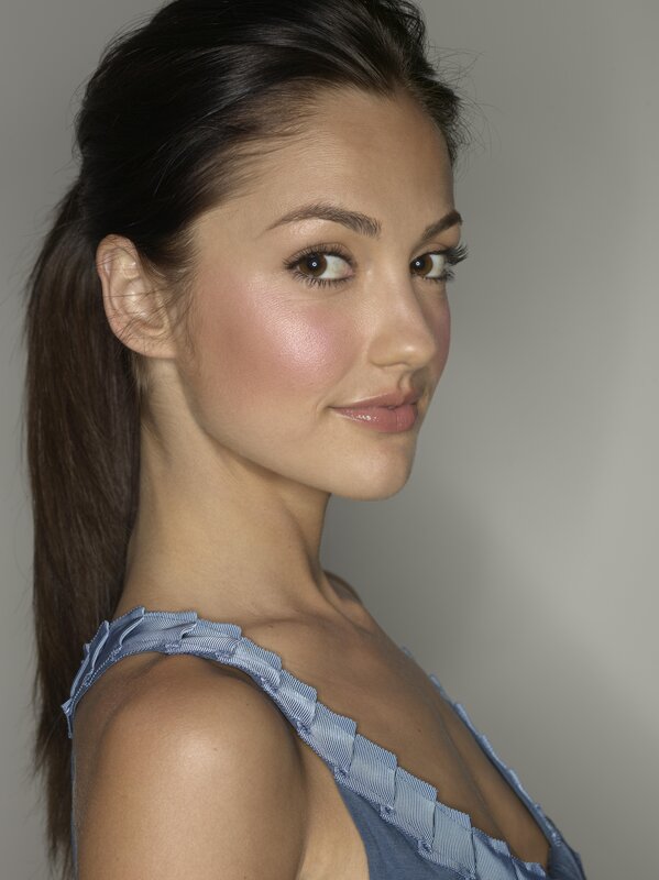 woman with ponytail in blue top