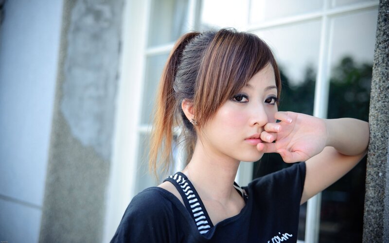 woman with ponytail near window