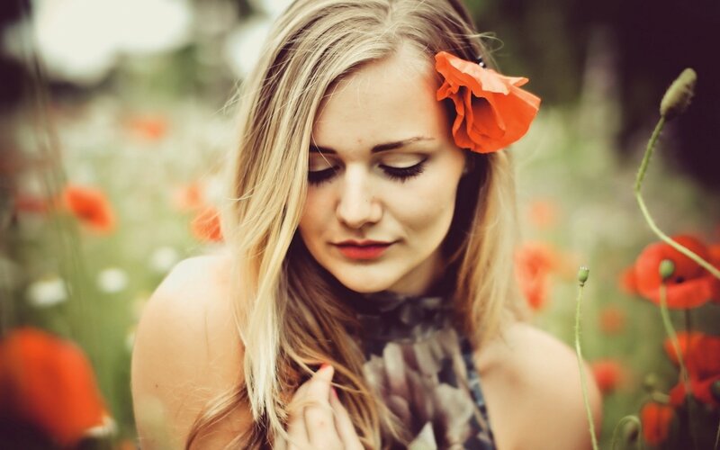 woman with poppy in hair