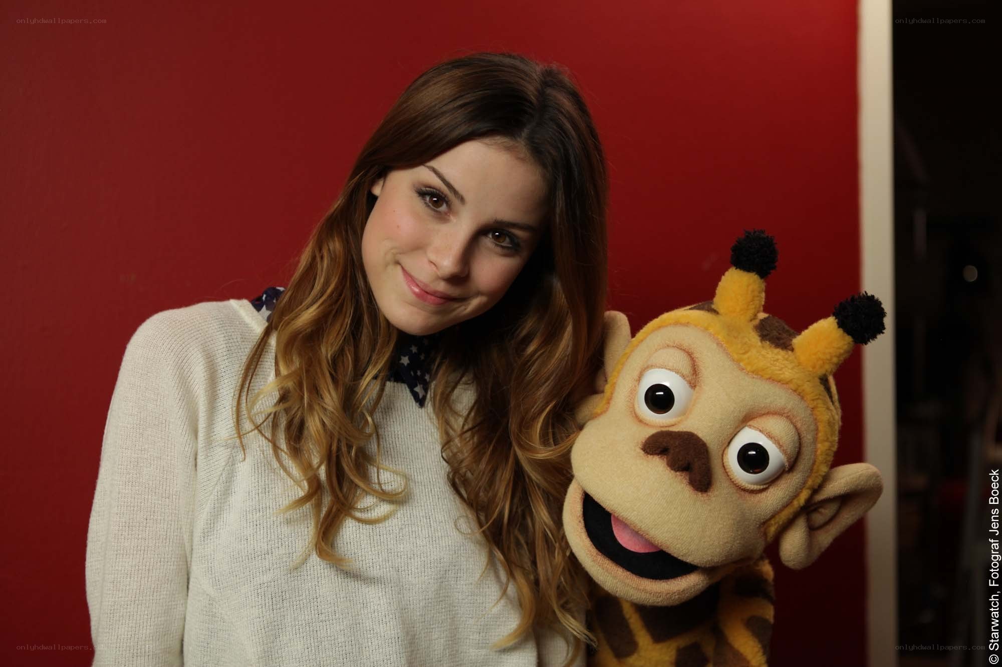 Woman with puppet on red background