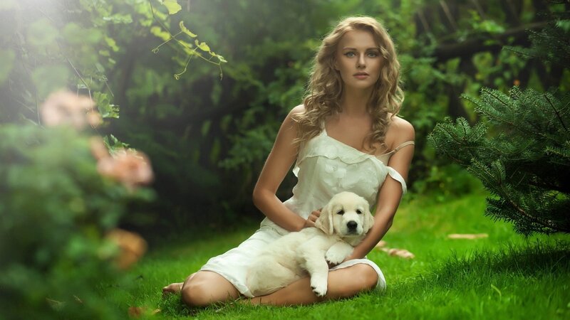 woman with puppy in garden