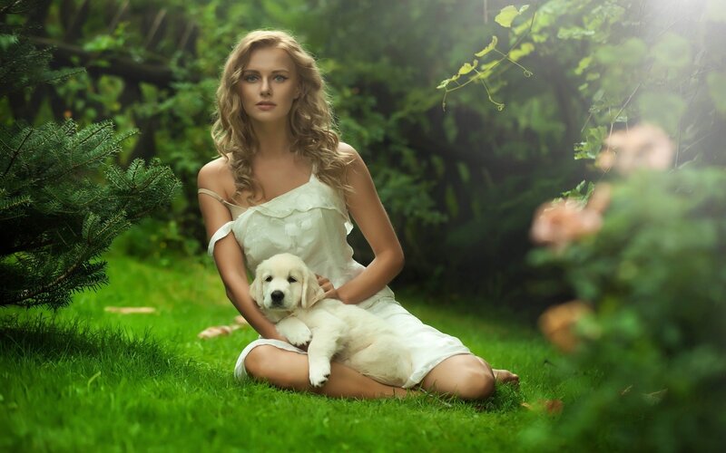 woman with puppy in garden