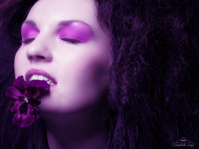 woman with purple flower