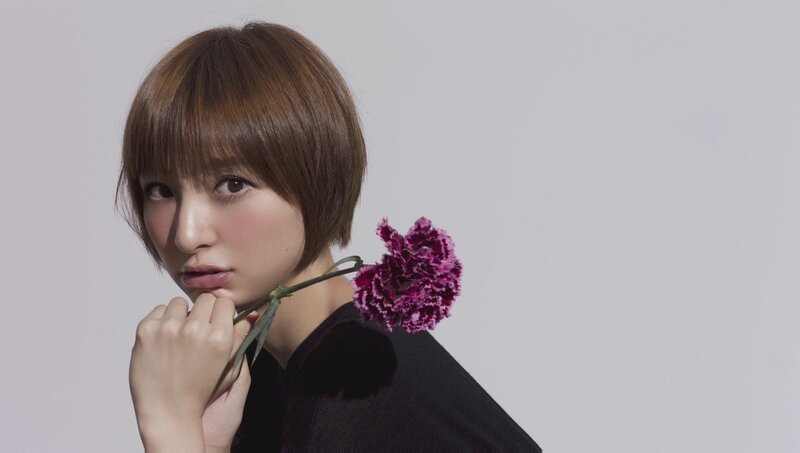 woman with purple flower