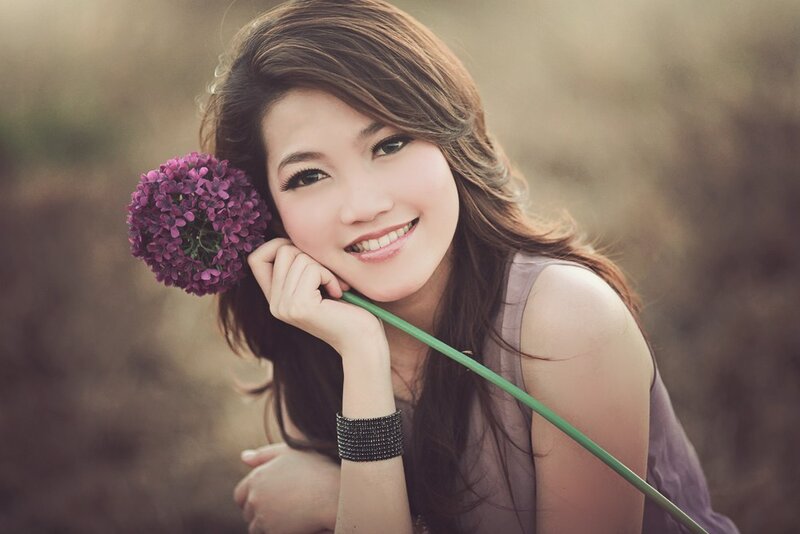 woman with purple flower