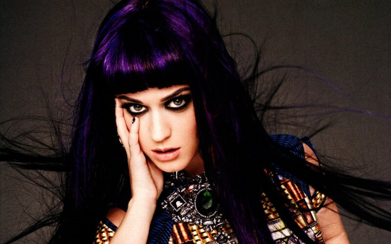 woman with purple hair and bold makeup