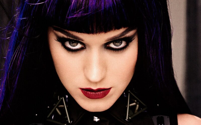 woman with purple hair and bold makeup
