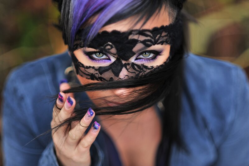 woman with purple hair and lace mask