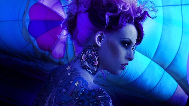 woman with purple hair and tattoos