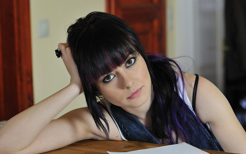 woman with purple hair at table