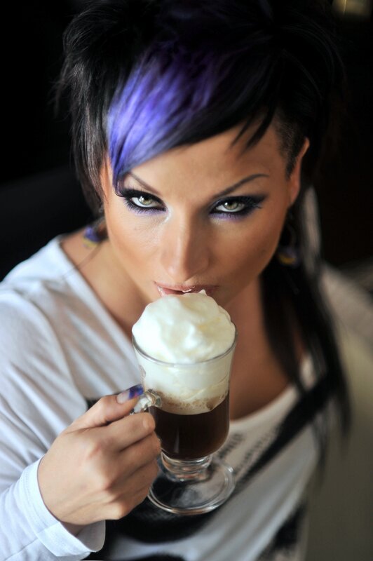 woman with purple hair drinking coffee