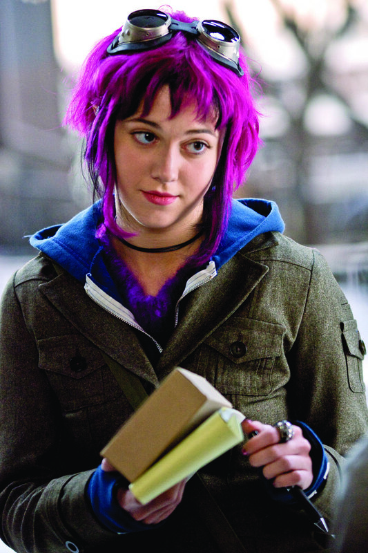 Woman with purple hair holding books