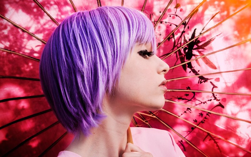 woman with purple hair holding umbrella