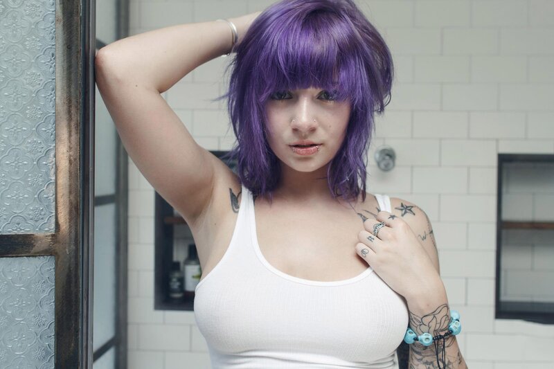woman with purple hair in bathroom