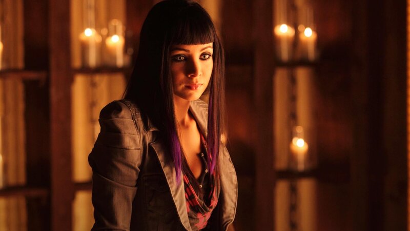 woman with purple hair in candlelight