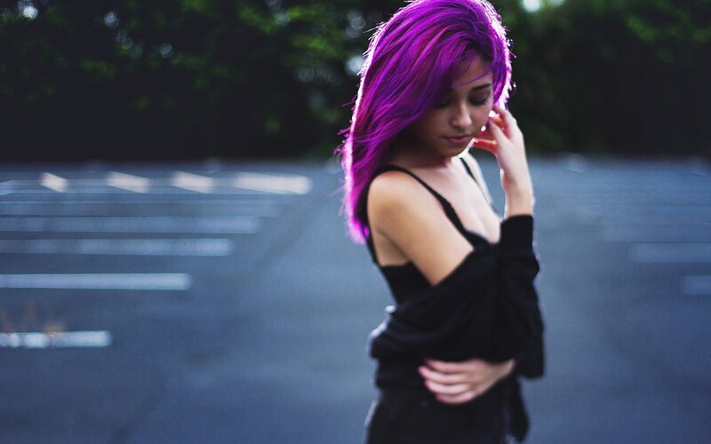 woman with purple hair in parking lot