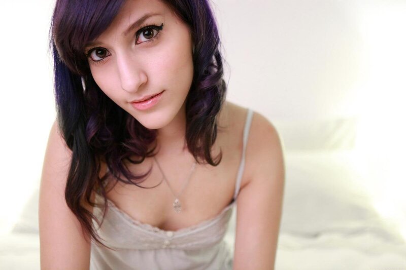 woman with purple hair in white room