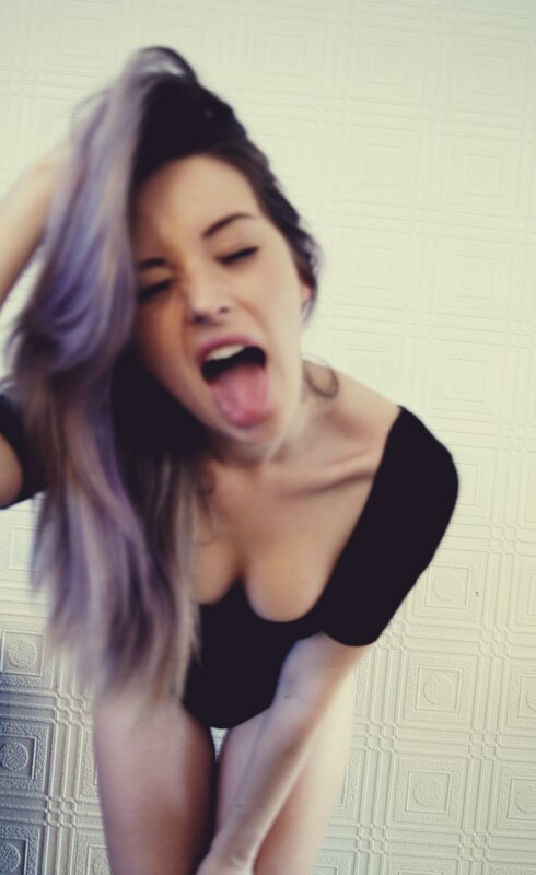 woman with purple hair making a face