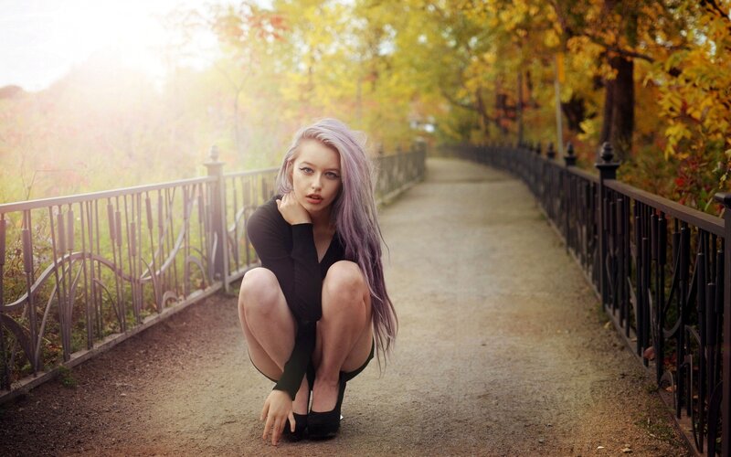 woman with purple hair on a bridge