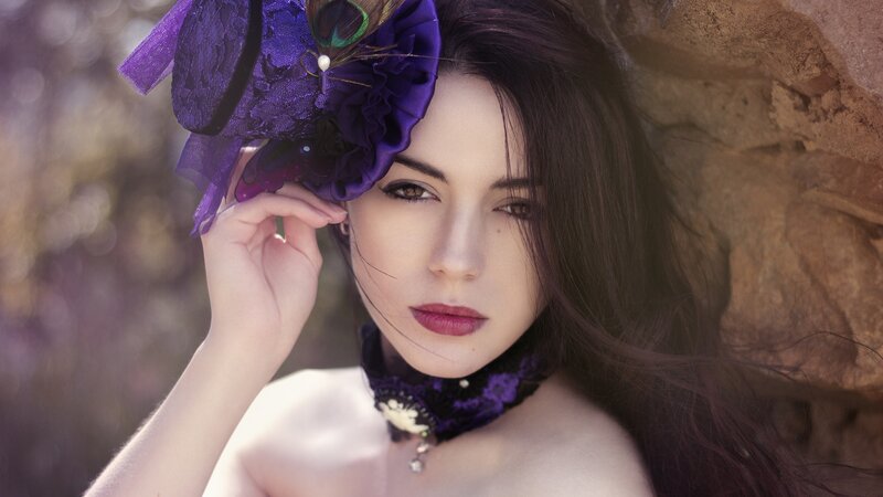 woman with purple hat and feather