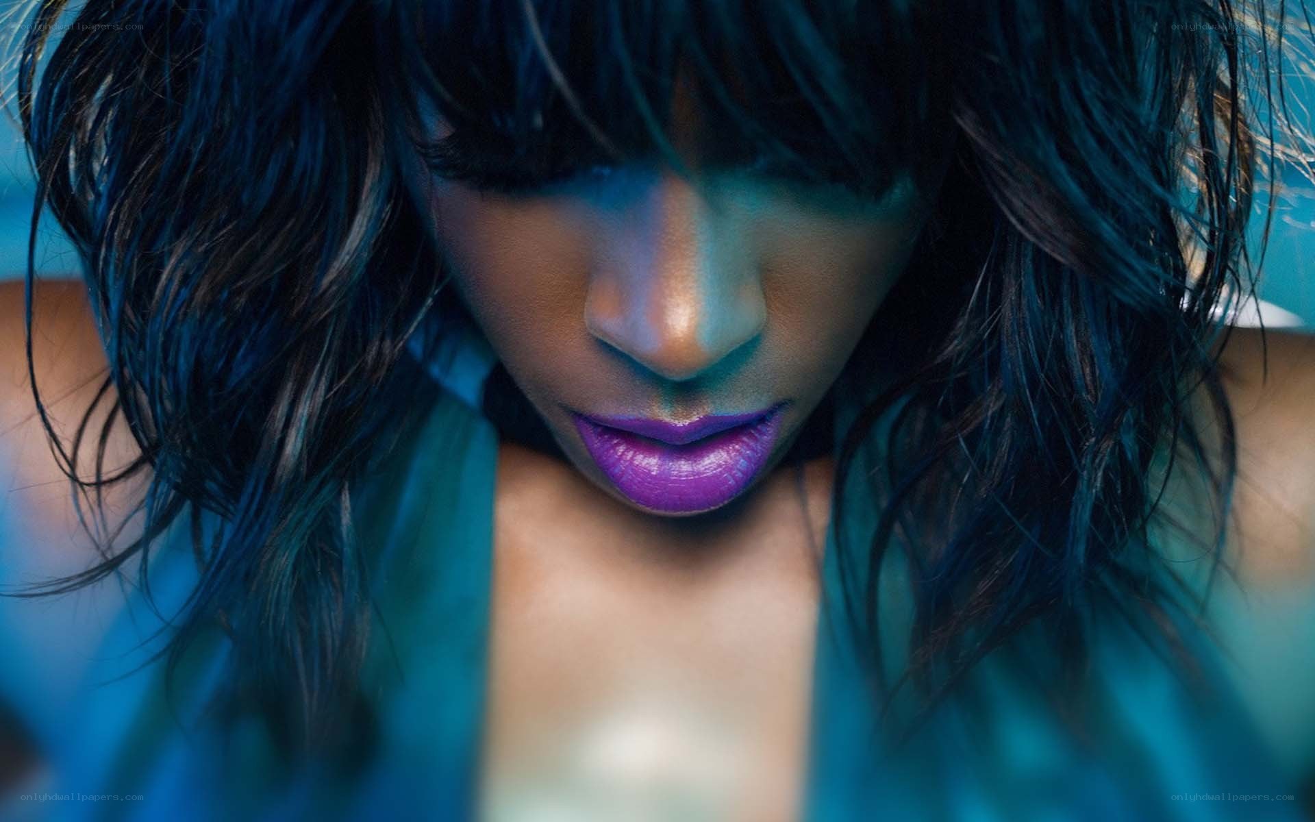 woman with purple lips looking down