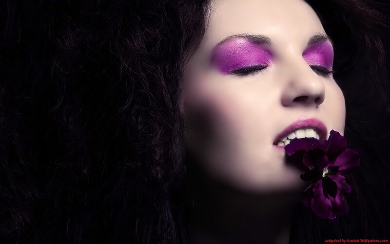 woman with purple makeup and flower