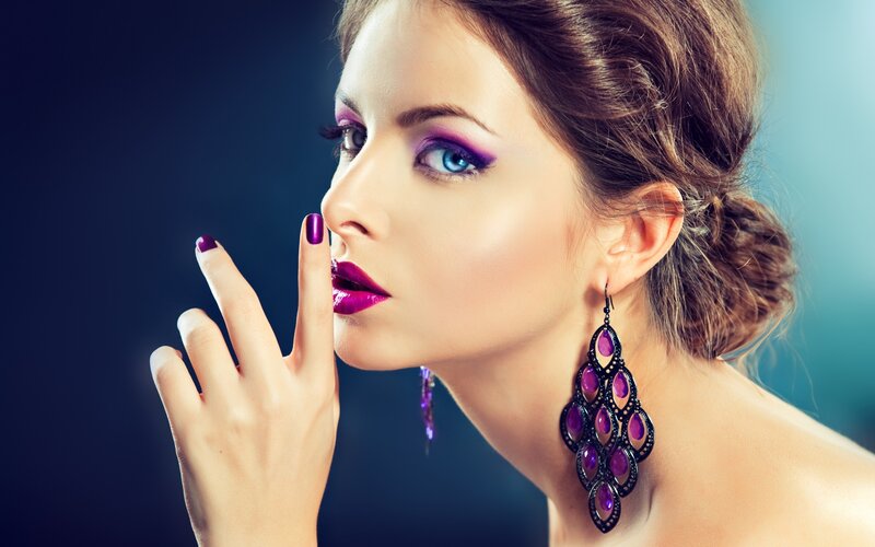 woman with purple makeup and jewelry