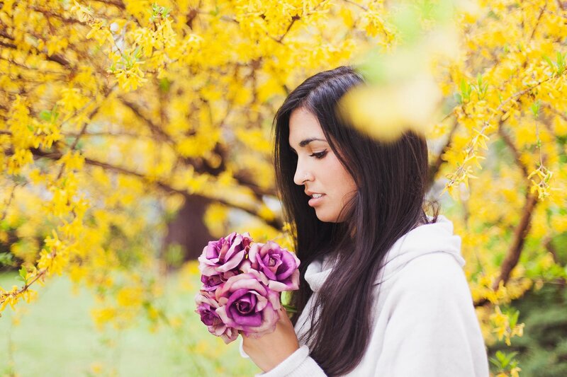woman with purple roses in spring