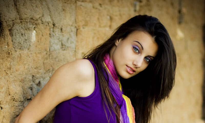 woman with purple top and scarf