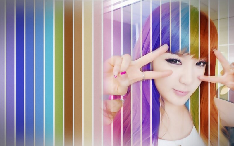 woman with rainbow hair making peace signs