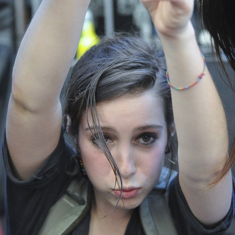 woman with raised arms at event