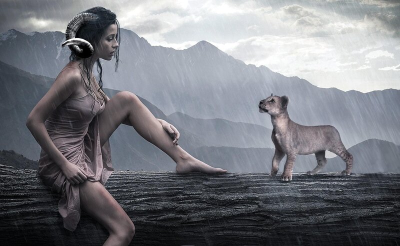 Woman with ram horns and lion cub