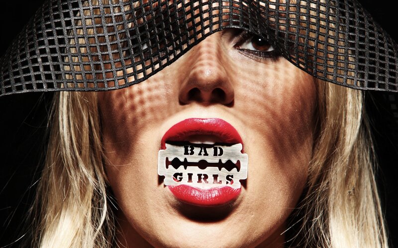 woman with razor blade in mouth