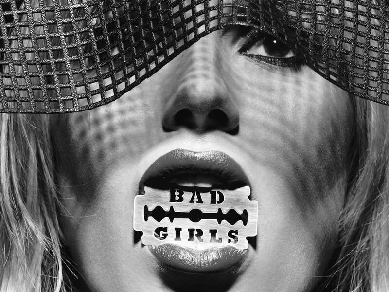 woman with razor blade in mouth
