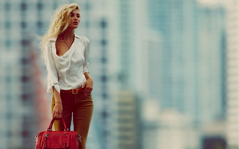 woman with red bag in city