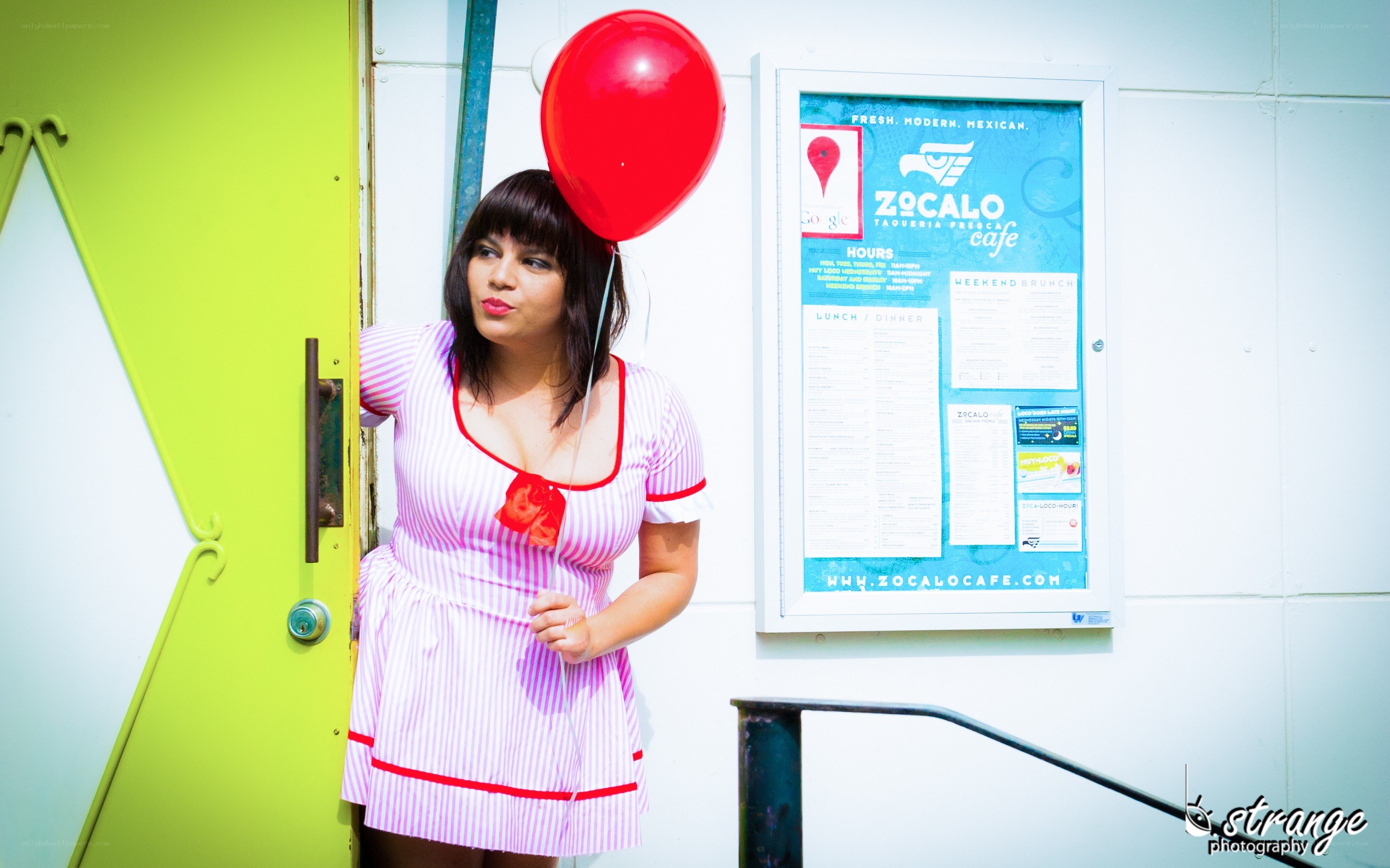 Woman with red balloon at cafe
