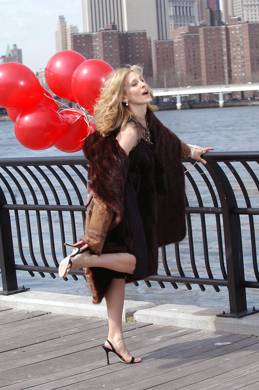 Woman with red balloons by the river