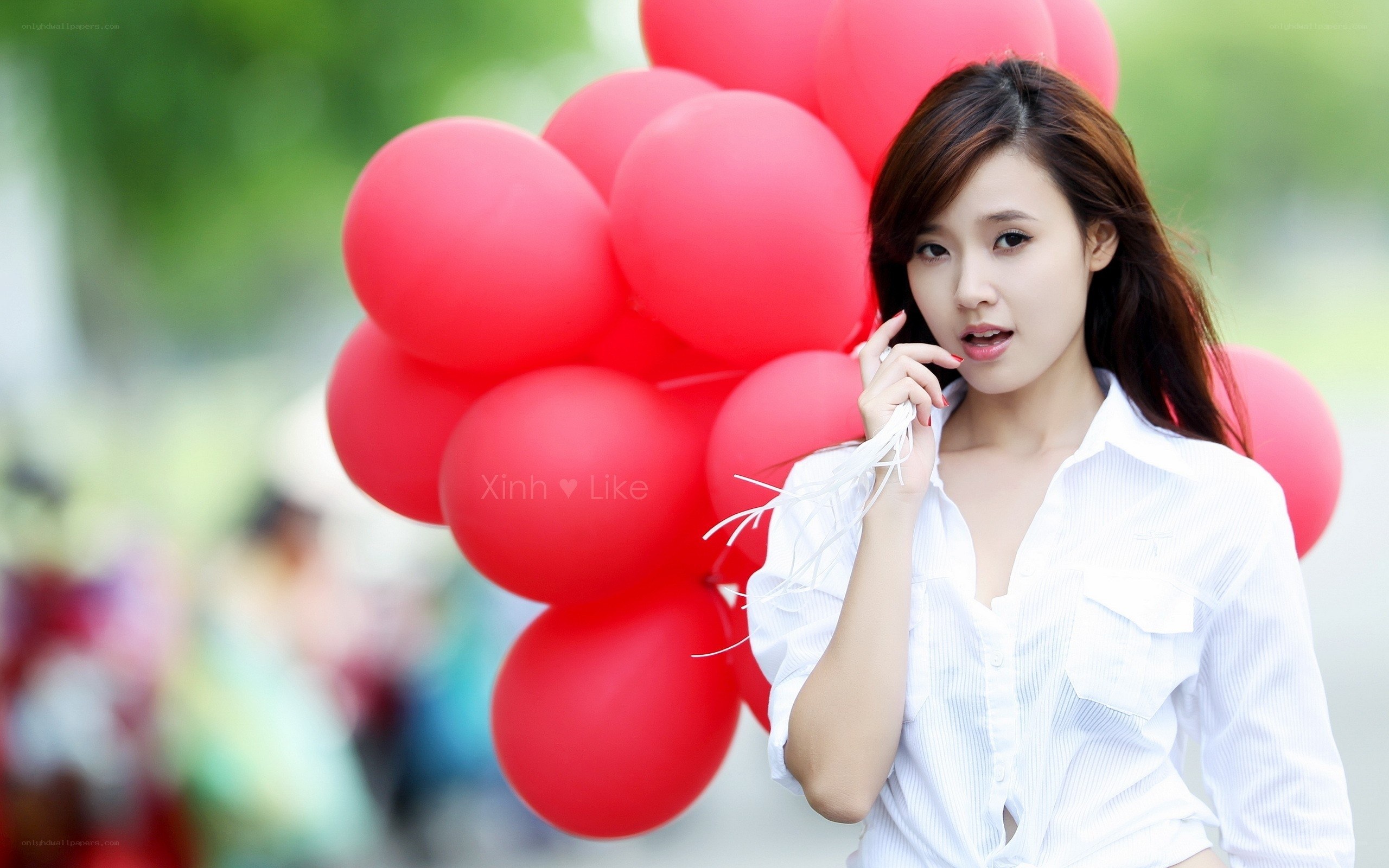Woman with red balloons