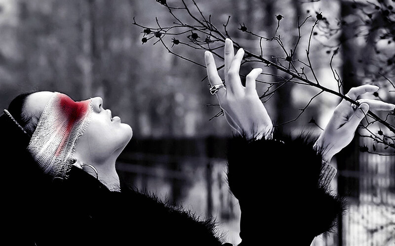 woman with red bandage on face
