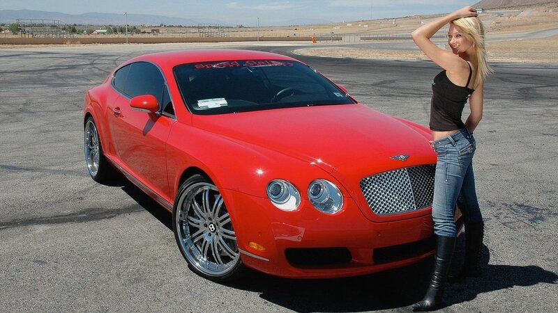 Woman with red Bentley on track