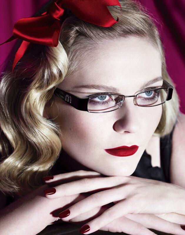 woman with red bow and glasses