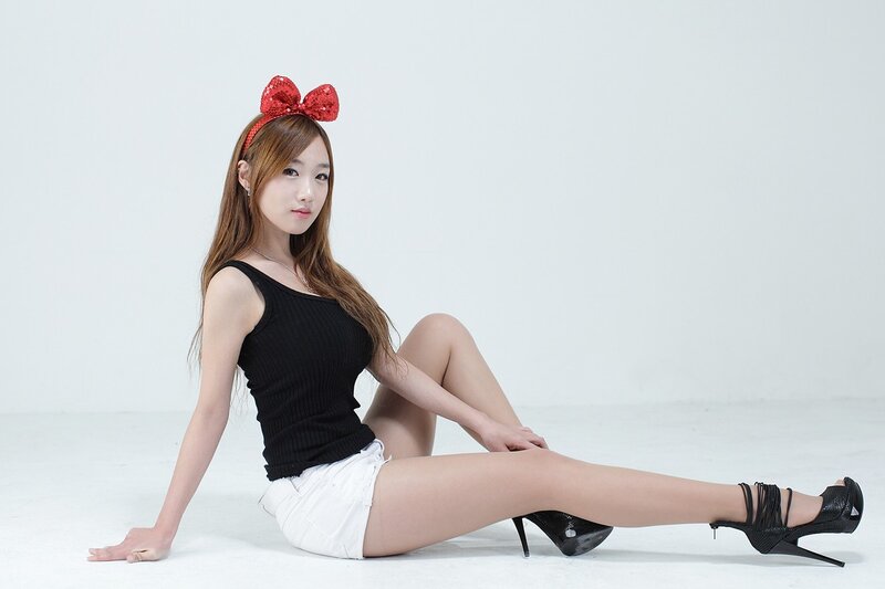 woman with red bow sitting on floor