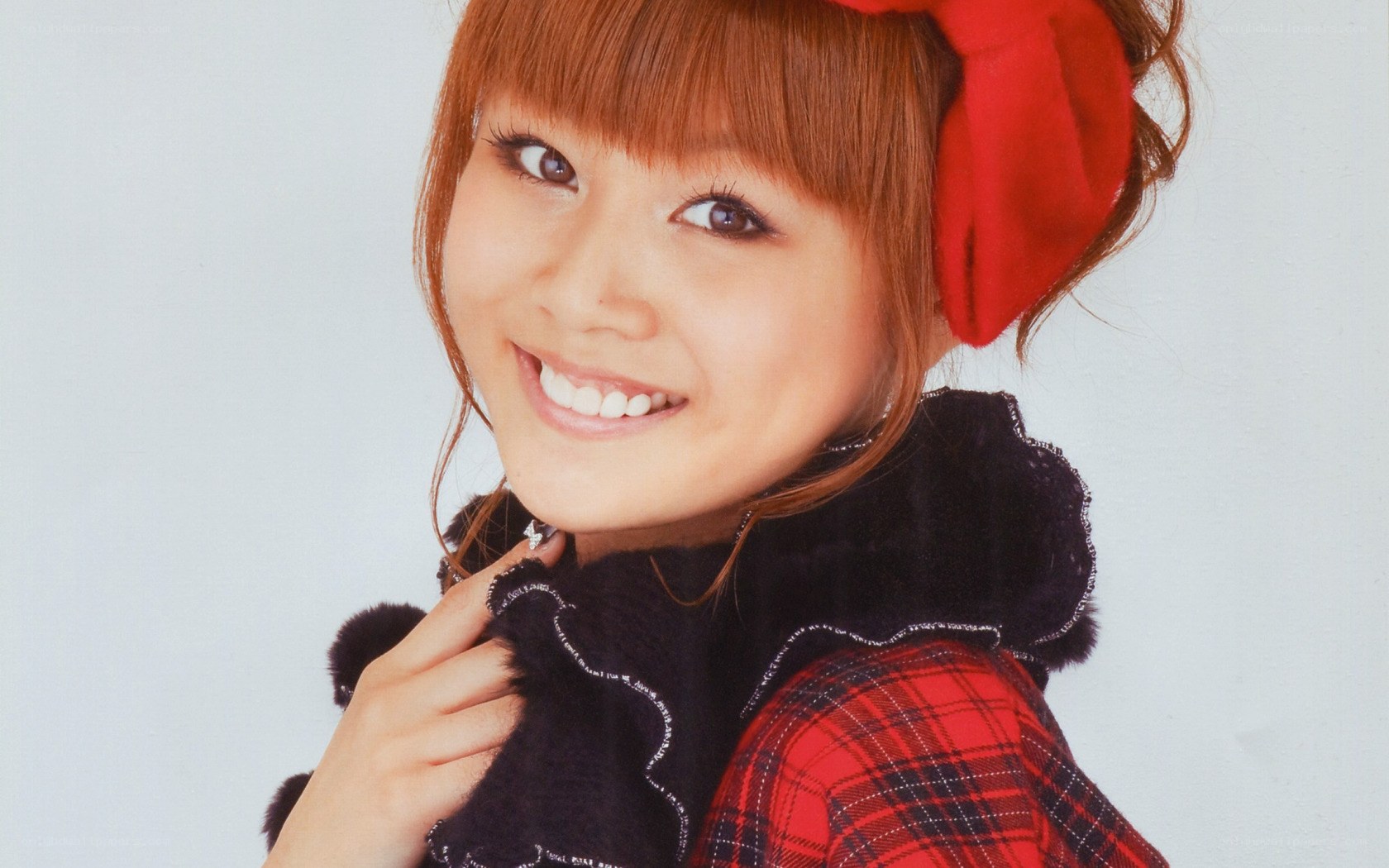 woman with red bow smiling